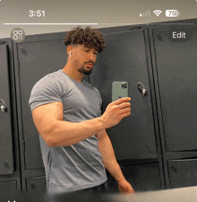 a man taking a picture of himself in a locker room with a time of 3:51