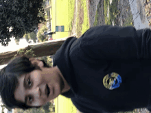 a young boy wearing a black shirt with a patch on the back that says ' california '