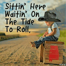 a young boy wearing a cowboy hat is sitting on a wooden box ..