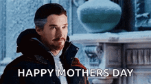 a man in a jacket is standing in front of a fireplace and says `` happy mother 's day '' .