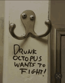 a hook on a wall that says drunk octopus wants to fight on it