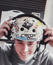 a person wearing a helmet that says crisp dogs