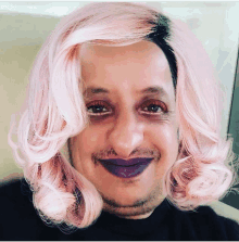 a man wearing a pink wig with purple lips