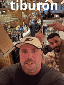 a group of men are posing for a picture in front of a bar that says tiburon