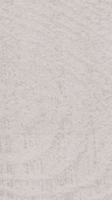 a close up of a piece of paper with a gray texture