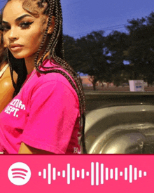 a woman in a pink shirt with the word dept on it is standing next to a truck