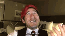 a man with red hair is wearing a suit and tie and says `` i 'm a mess ! ''