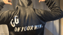 a person wearing a black hoodie that says " on your win "