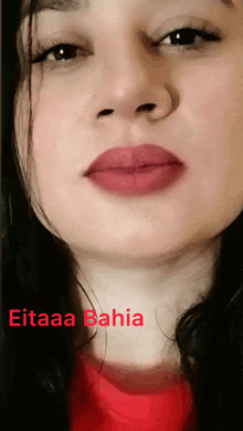 a close up of a woman 's face with the name eitaaa bahia written below her