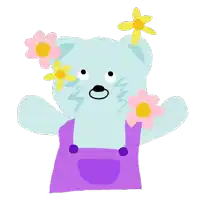 a blue teddy bear wearing purple overalls and pink flowers