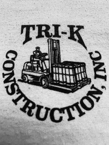 a black and white logo for trik construction inc