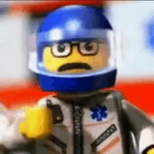 a close up of a lego man wearing a blue helmet and glasses .