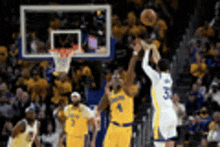 a blurry picture of a basketball game with a player wearing number 5 shooting a shot