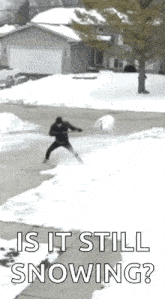 a man is shoveling snow in front of a house with the words " is it still snowing " below him