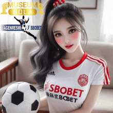 a woman holding a soccer ball wearing a sbobet shirt