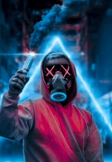 a man wearing a gas mask is holding a flare in his hand .