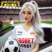 a woman holding a soccer ball wearing a shirt that says bobet