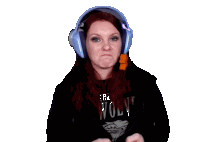 a woman wearing headphones and a shirt that says " the wolves "