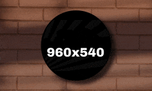 a brick wall with a black circle that says 960x540 on it