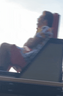 a blurry photo of a person sitting on a chair