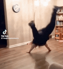 a person doing a handstand in a living room with a tiktok watermark