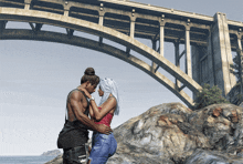 a man and a woman standing under a bridge