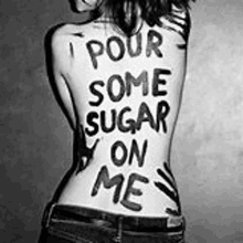 a black and white photo of a woman 's back with the words `` pour some sugar on me '' written on it .