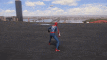 a man in a spiderman suit is running on a roof