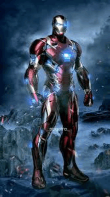 iron man is standing on top of a rocky hill in a suit .