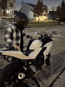 a man standing next to a white motorcycle