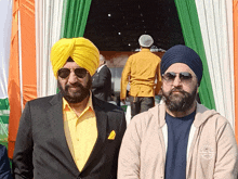 two men wearing turbans and sunglasses are standing next to each other and one of them is wearing a hoodie that says california