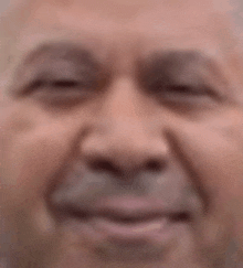 a close up of an elderly man 's face with his eyes closed .