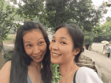 two women are posing for a picture and smiling