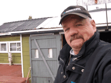 a man wearing a black jacket and a hat that says proztek