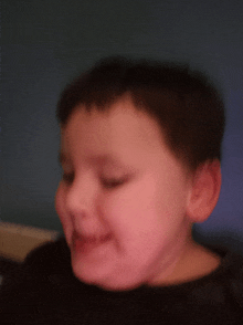 a blurry picture of a child 's face with a blue background