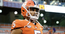 a clemson football player wearing a helmet and number 5 jersey