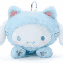 a blue and white cat stuffed animal with a keychain attached to it .