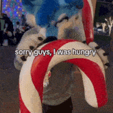 a person in a furry costume holding a candy cane that says sorry guys i was hungry on it