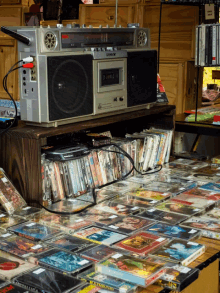 a sony radio sits on top of a shelf filled with cd 's