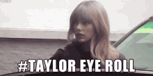 a woman is standing in front of a car with the words #taylor eye roll above her