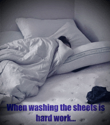 a person laying on a bed with the words " when washing the sheets is hard work " above them