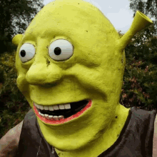 a shrek statue with big eyes and a red lip