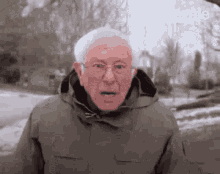 bernie sanders is making a funny face while wearing a jacket and glasses .