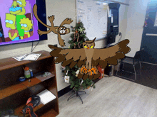 a cartoon drawing of an owl and a squirrel standing next to a christmas tree in a room