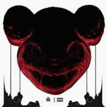 a black and red mickey mouse head with a red mouth and teeth hanging from strings .