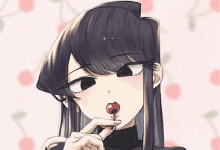 a girl with long black hair is licking a red cherry