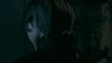 a close up of a person 's head in a dark room in a video game .