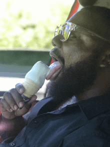 a man with a beard is eating an ice cream cone with a sticker that says ' ice cream ' on it