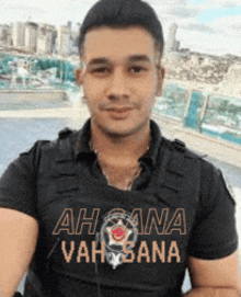 a man wearing a shirt that says ah sana vah sana on it