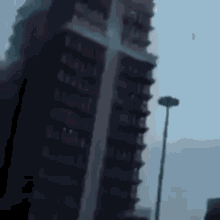 a very tall building with a cross on the side